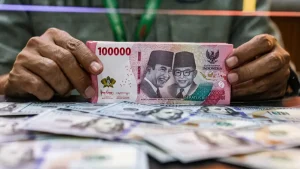 Rupiah Terancam Melemah ke Rp 18.060: Bagaimana Gubernur BI Perry Warjiyo Berdampak pada Pasar?